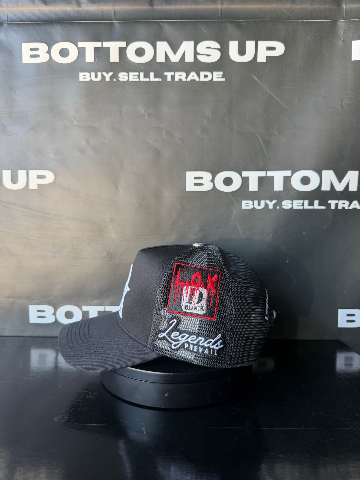 Legends Prevail x LOX Trucker Hat In Black
