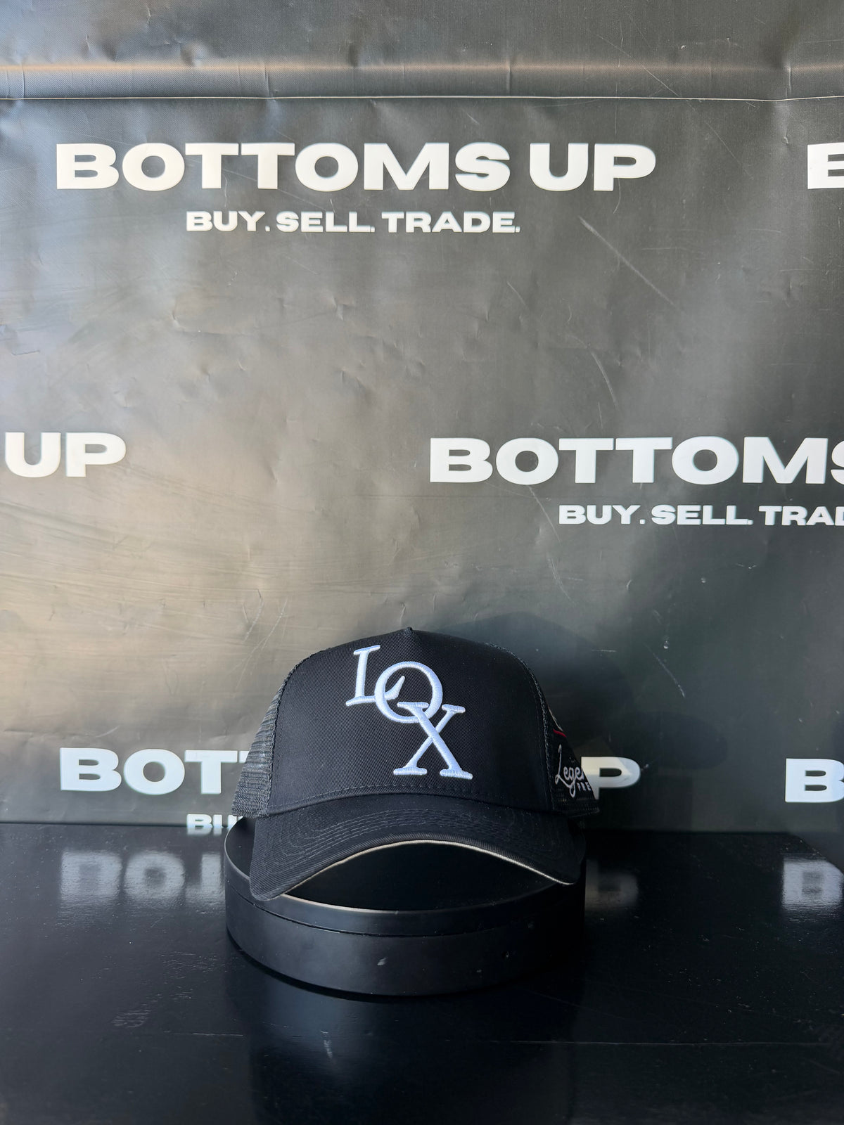 Legends Prevail x LOX Trucker Hat In Black
